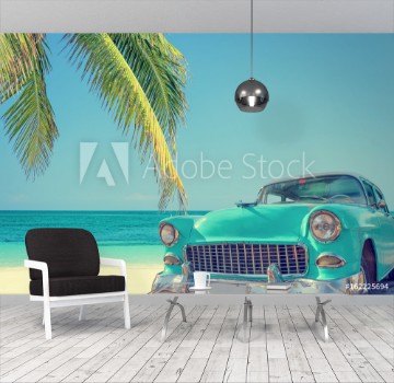 Picture of Classic car on a tropical beach with palm tree vintage process